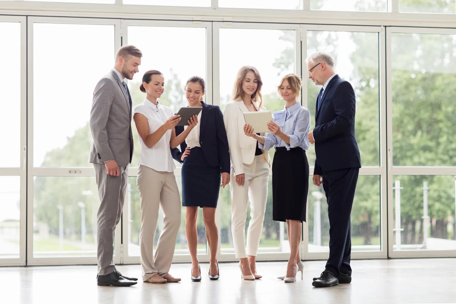 Business colleagues using tablets together in an office.