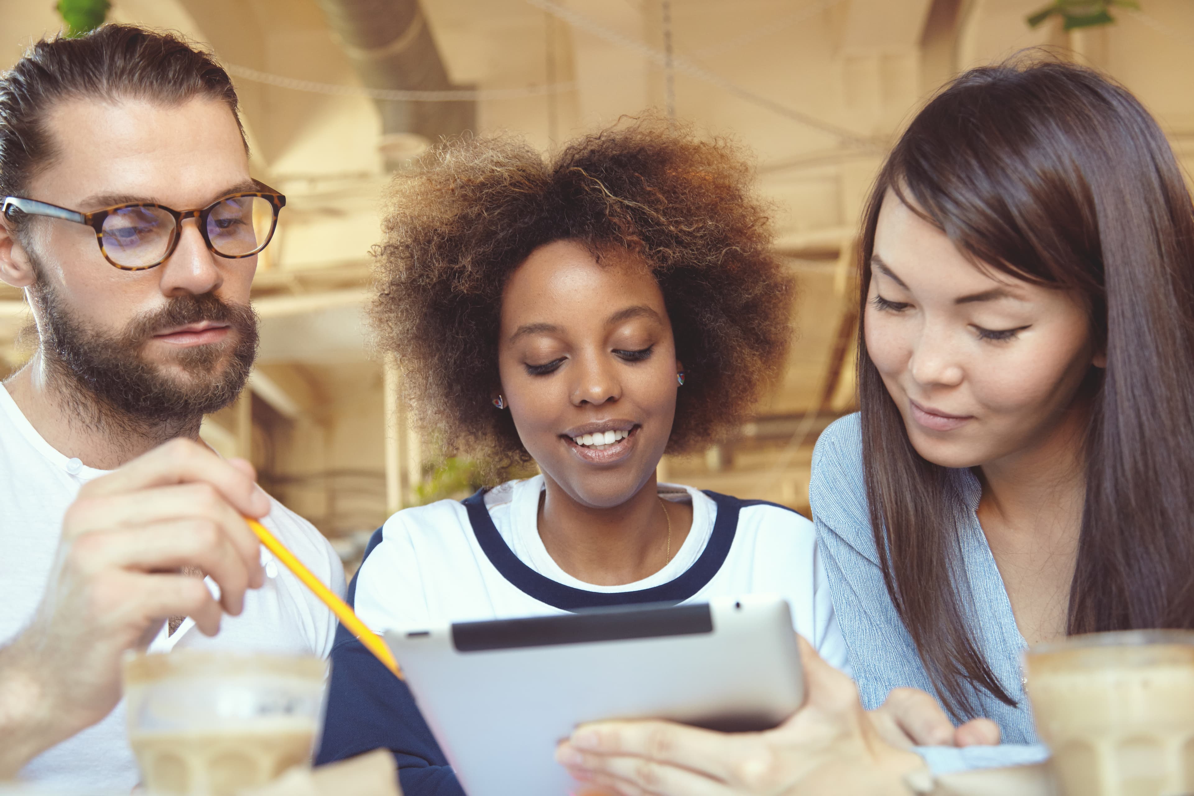 Colleagues planning work together around a tablet.