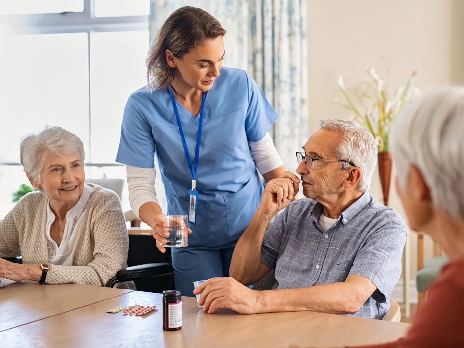 Care worker supporting people with medication during a care visit