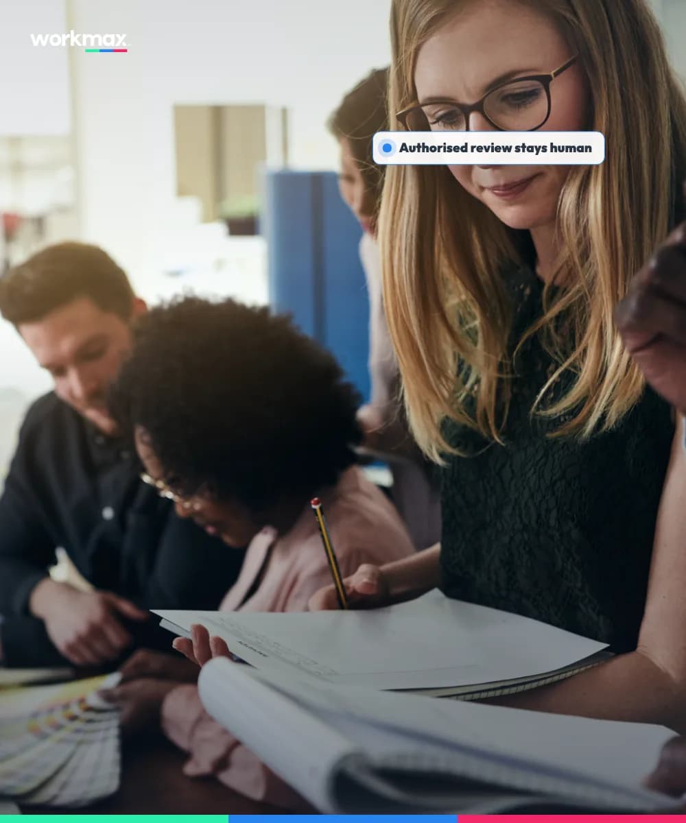 Manager and colleague reviewing workforce evidence together in a modern office